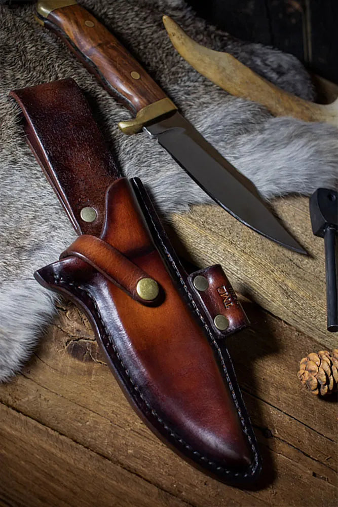 A handcrafted leather knife sheath with the knife out beside the sheath