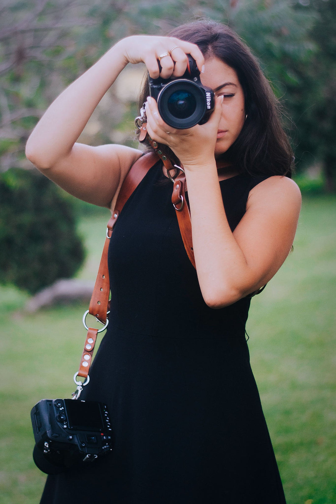 A beauty women holds a beauty camera strap