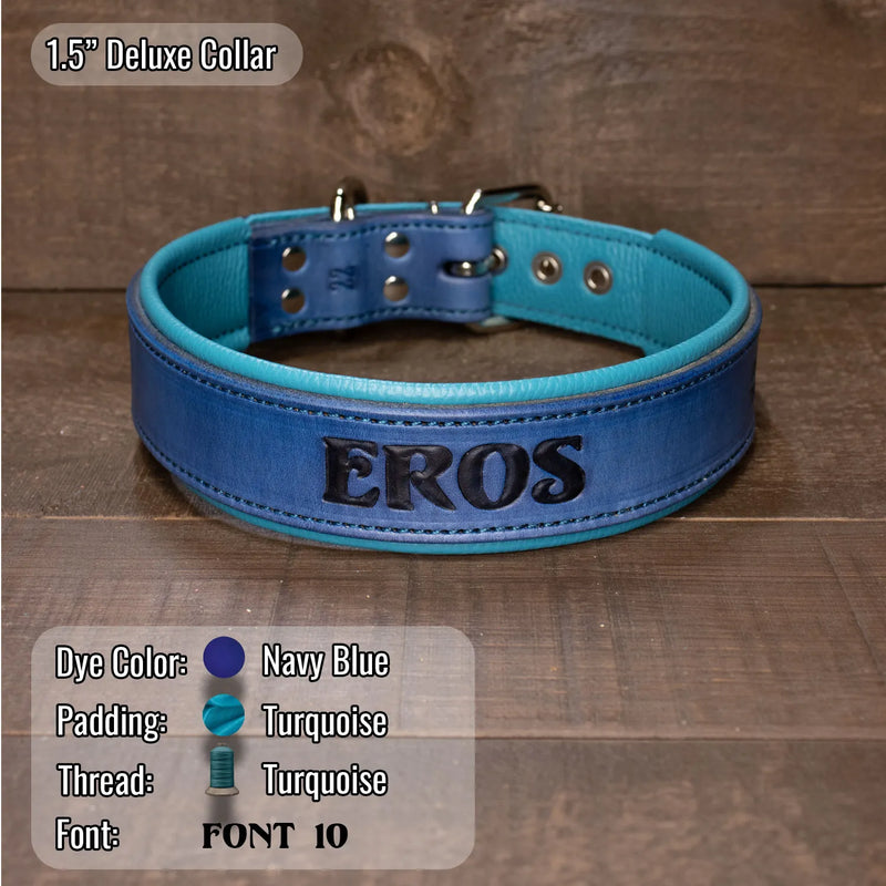 A personalized leather dog collar in navy blue and turquoise, featuring the name 'EROS' embossed by hand on the front. The collar is displayed on a rustic wooden background with a color specification overlay at the bottom left detailing the colors and font.