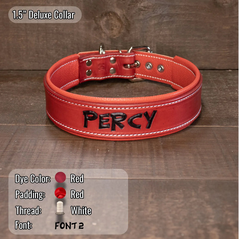 A red leather dog collar with white stitching and the name 'PERCY' in black lettering, displayed on a dark wood background with product details and color swatches shown in the lower corners.