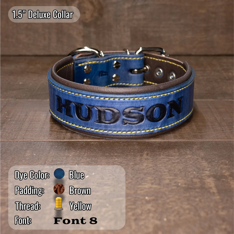 A blue leather dog collar with brown leather interior, yellow stitching, and the name 'HUDSON' in black hand tooled and dyed lettering, displayed on a wooden surface. Text overlays show the product details and color information.